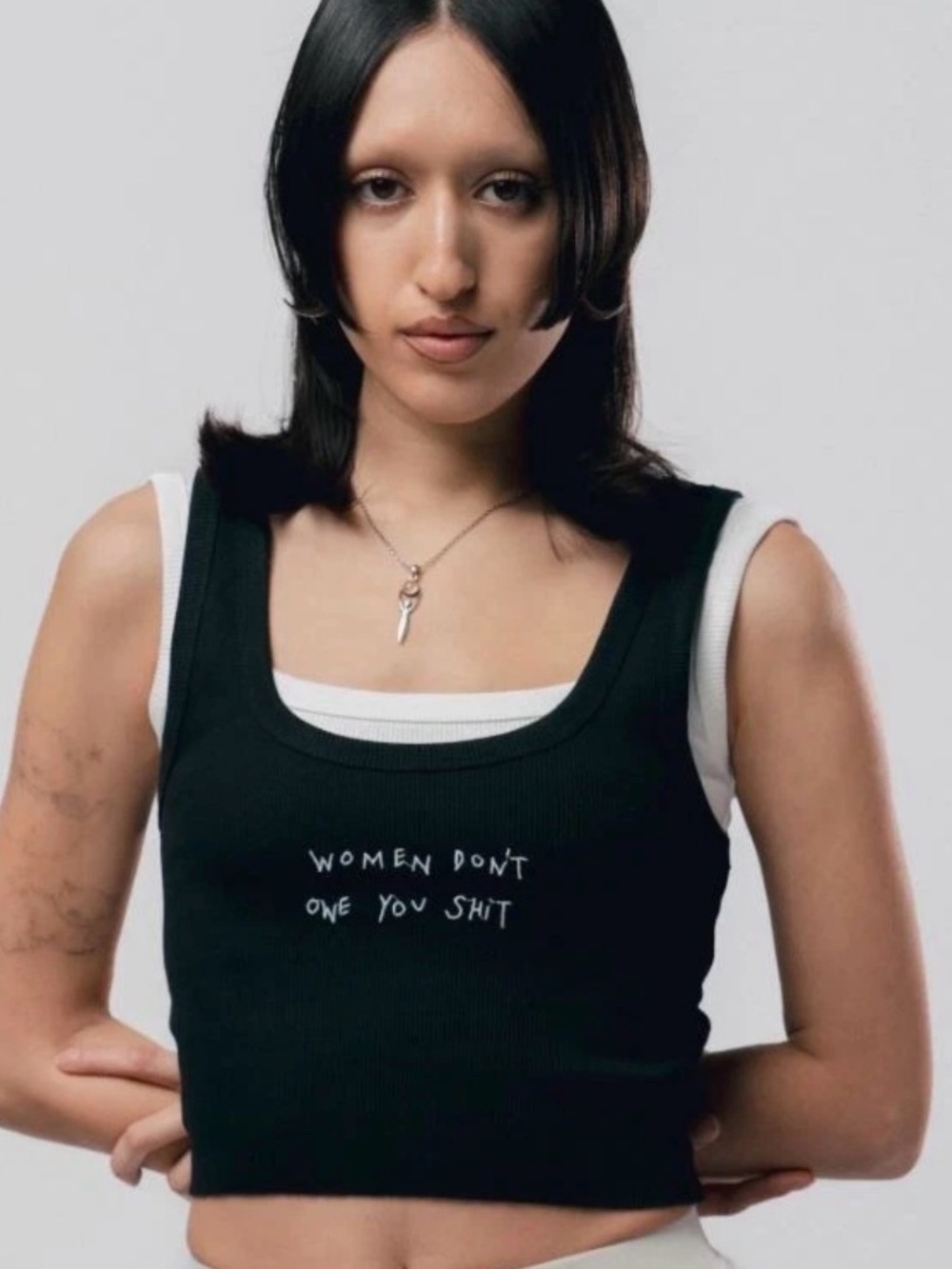 CHNGE Women's "Women Don't Owe You Shit" Black Distressed Hem Crop Tank Top